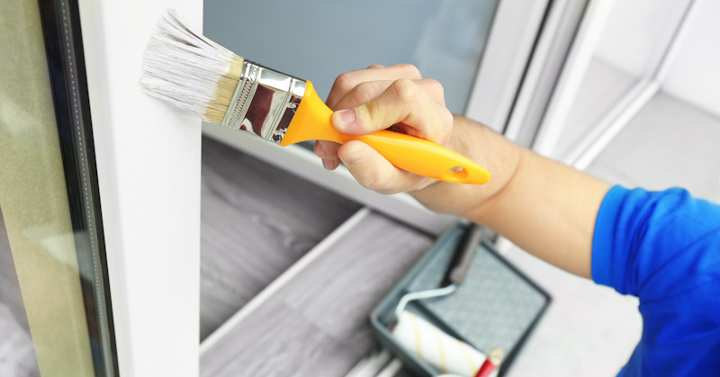 Young,Man,Painting,Window,At,Home,,Closeup